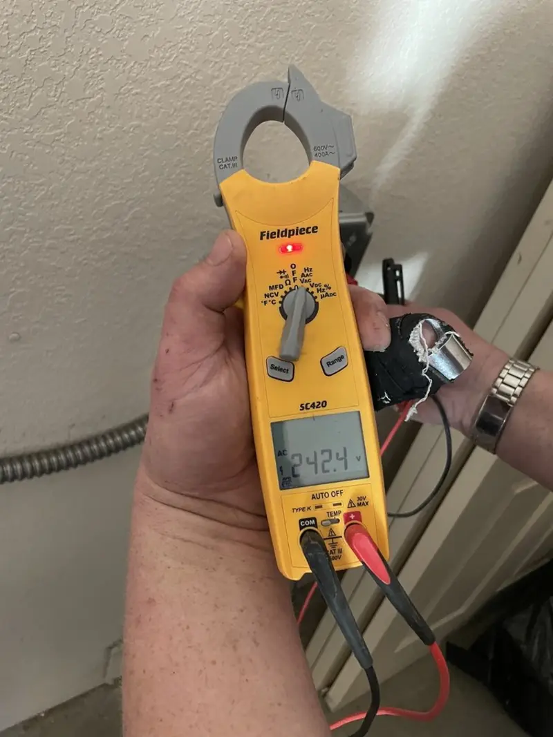 Voltage testing with clamp meter during Recessed Lighting Installation in Skokie